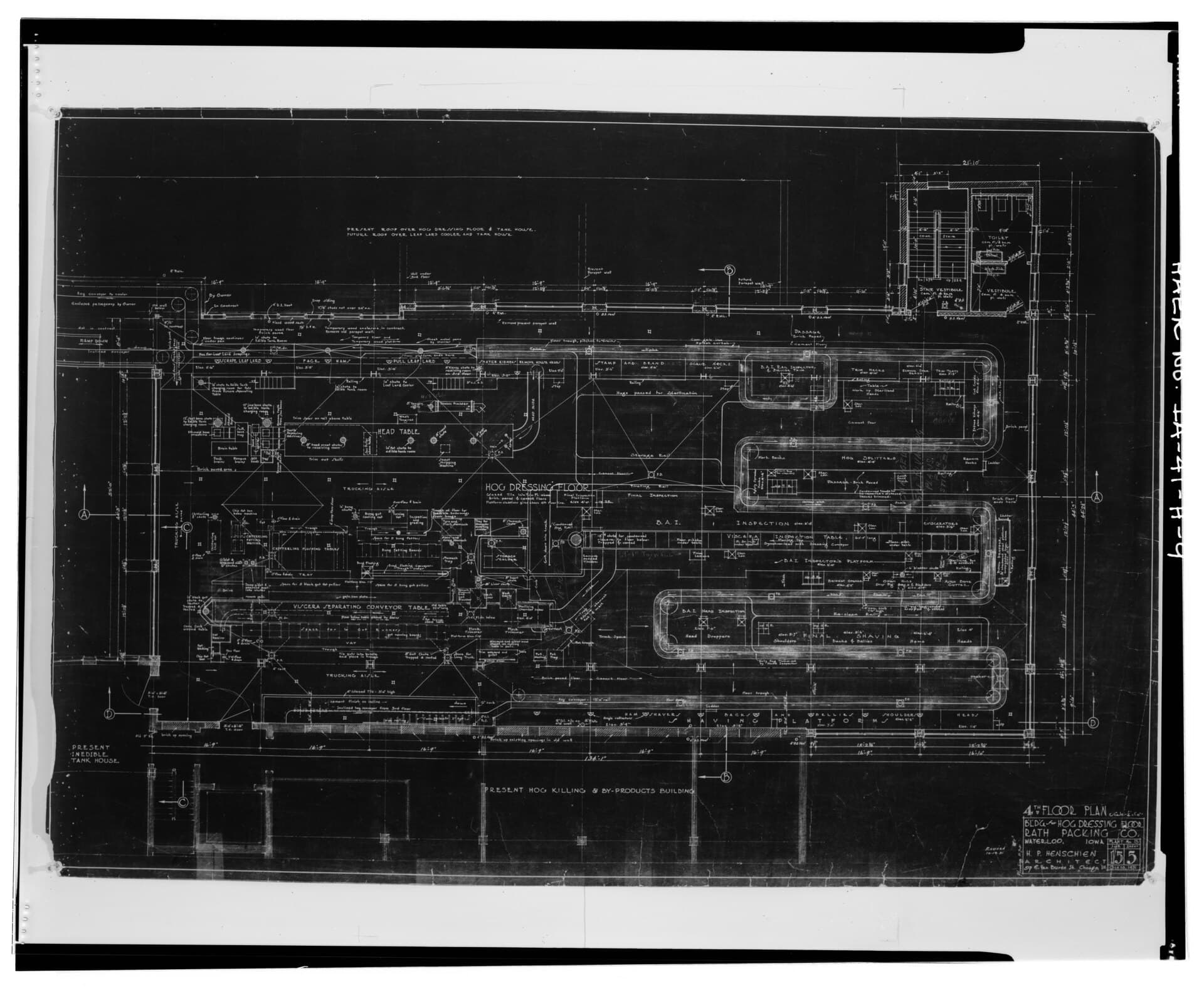 Historic architectural blueprint photographed on a drawing board